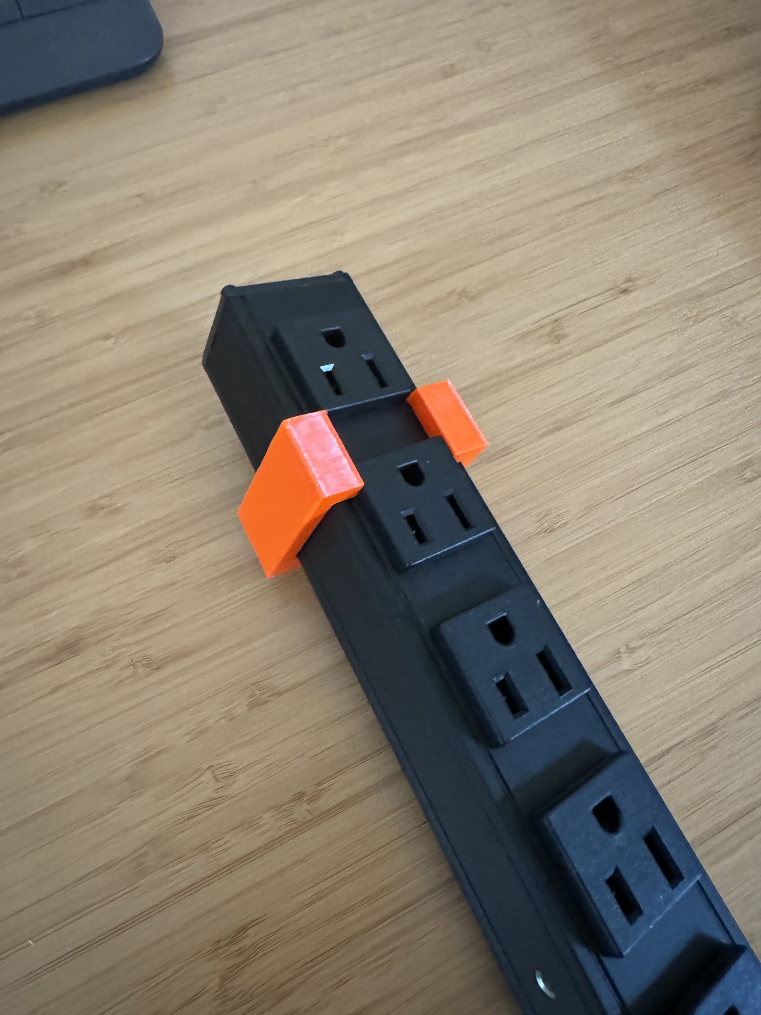 Trying an orange bracket on the power strip.