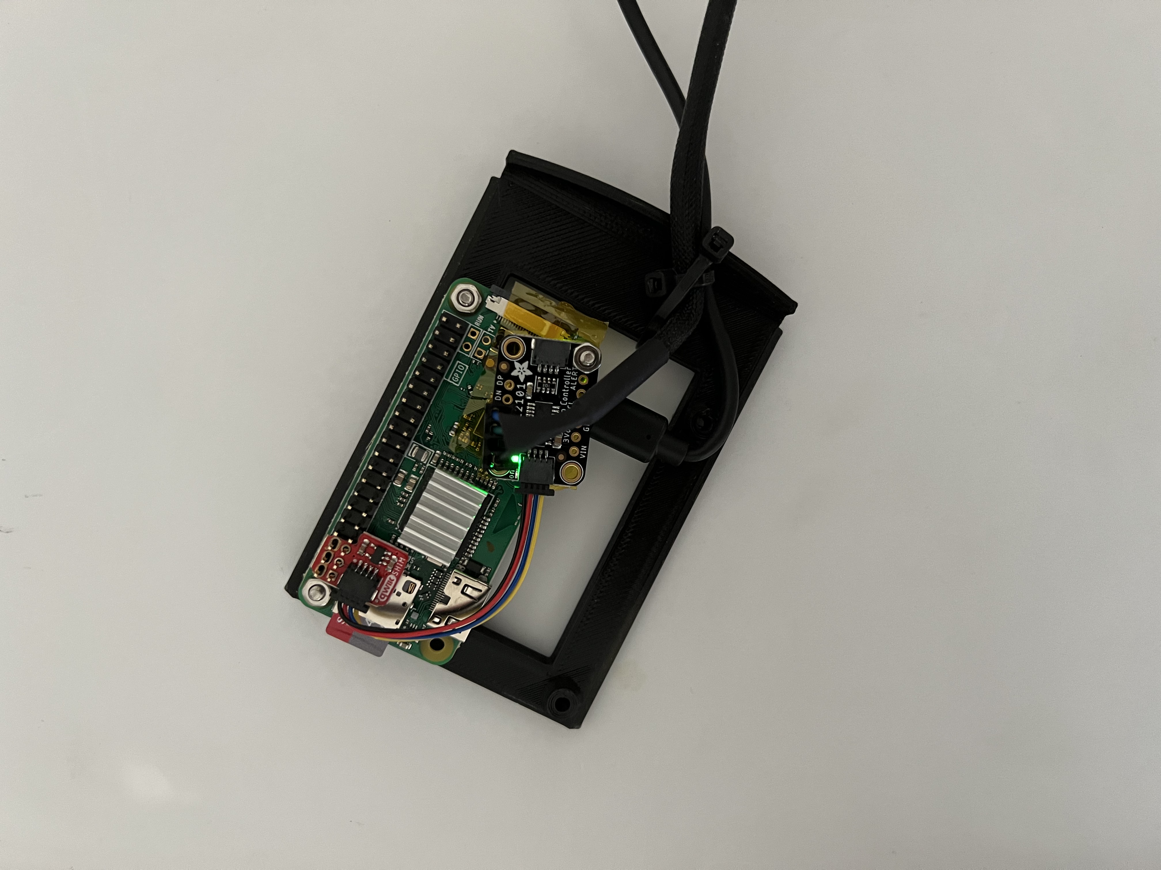 Raspberry Pi Zero W with the fan controller board mounted in a black bracket
