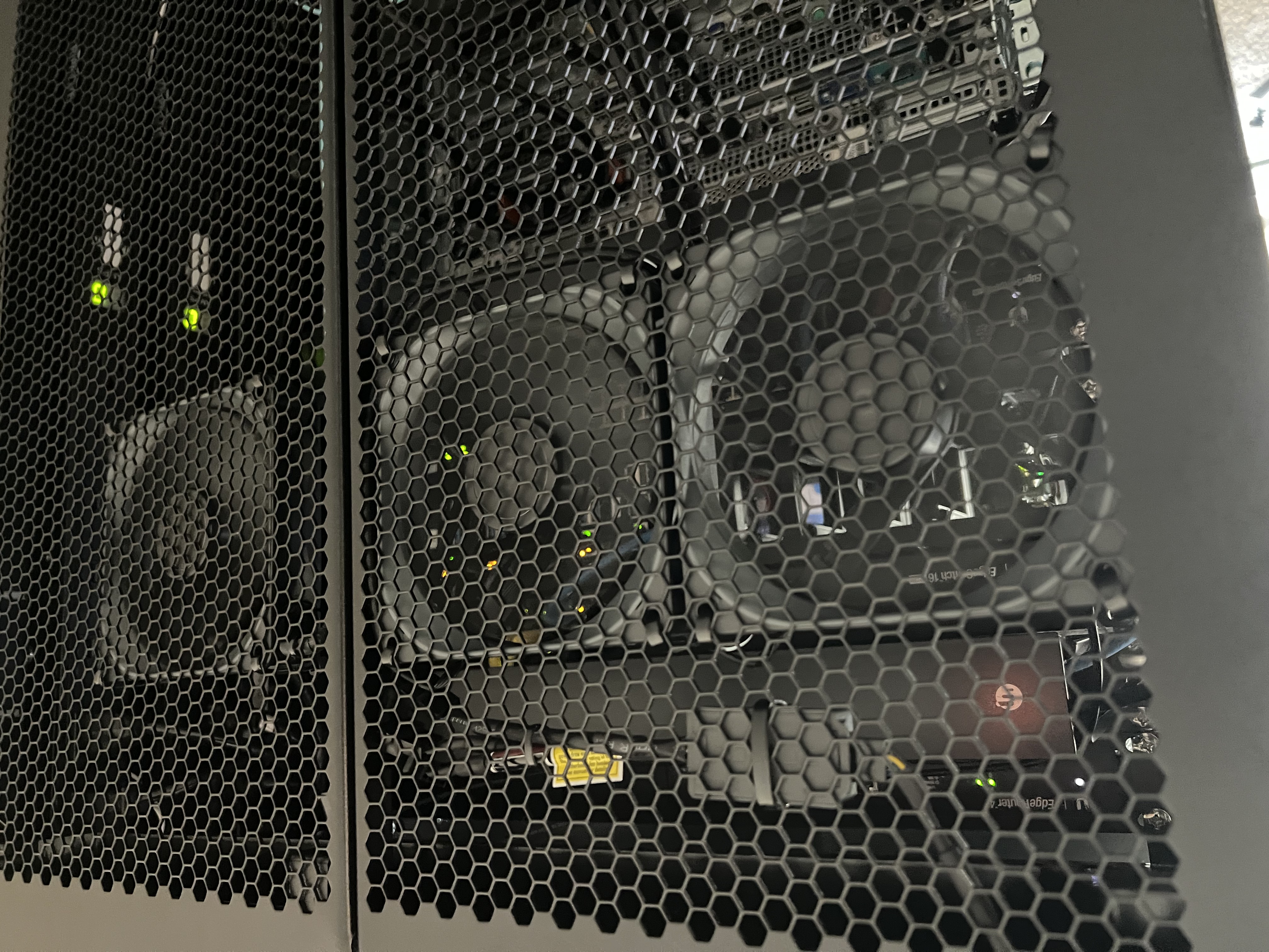 The rack doors closed with the cooling fans visible behind the mesh