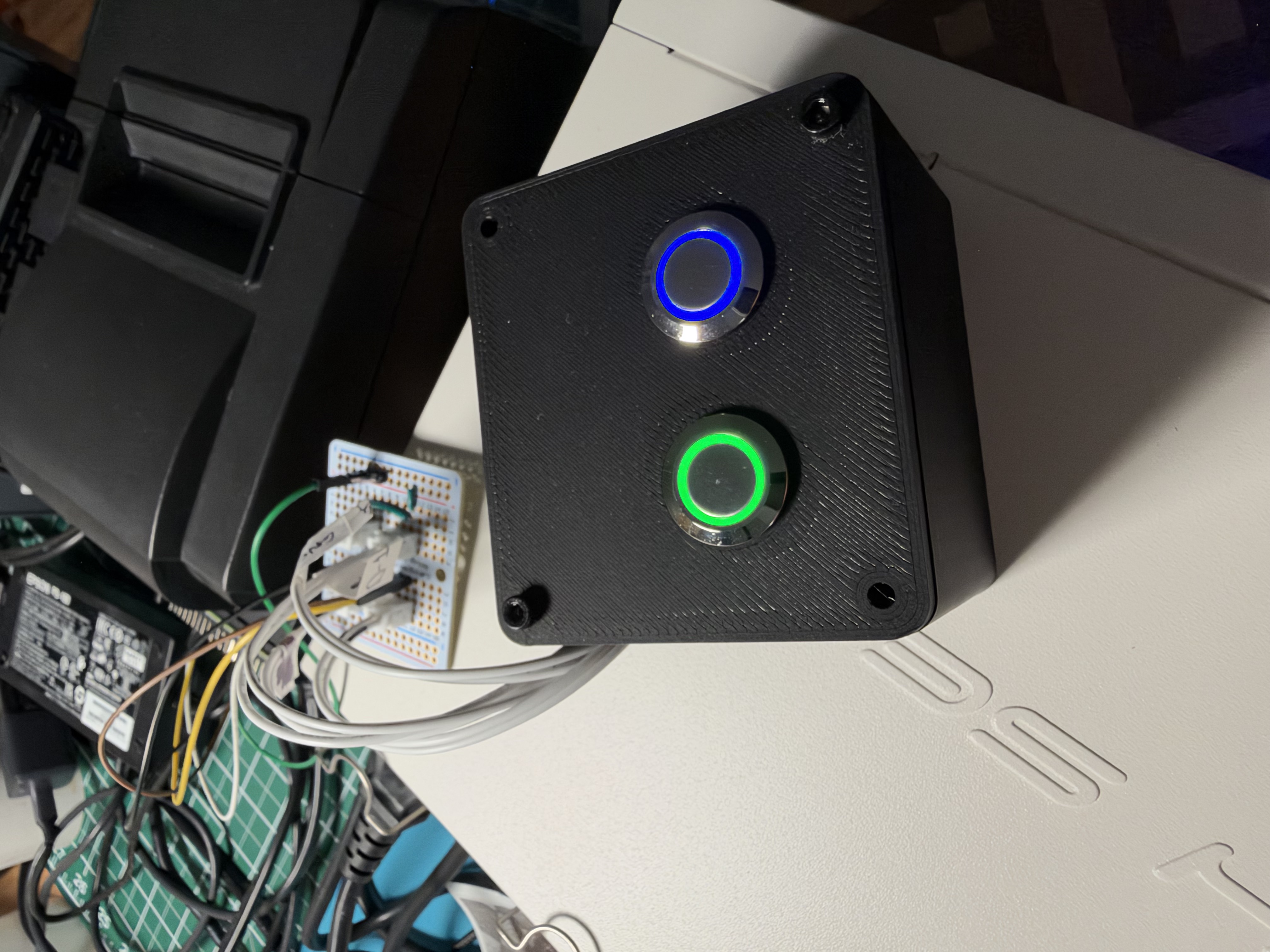 Green and blue illuminated buttons mounted in a black 3D-printed enclosure